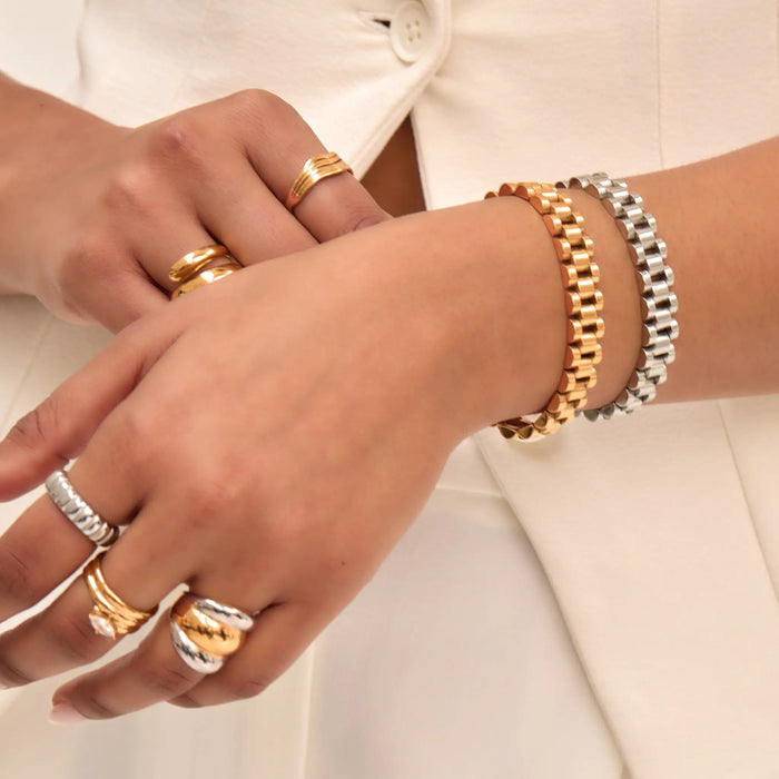 Model wearing gold and silver watch strap bracelet and mixed metal rings from prya
