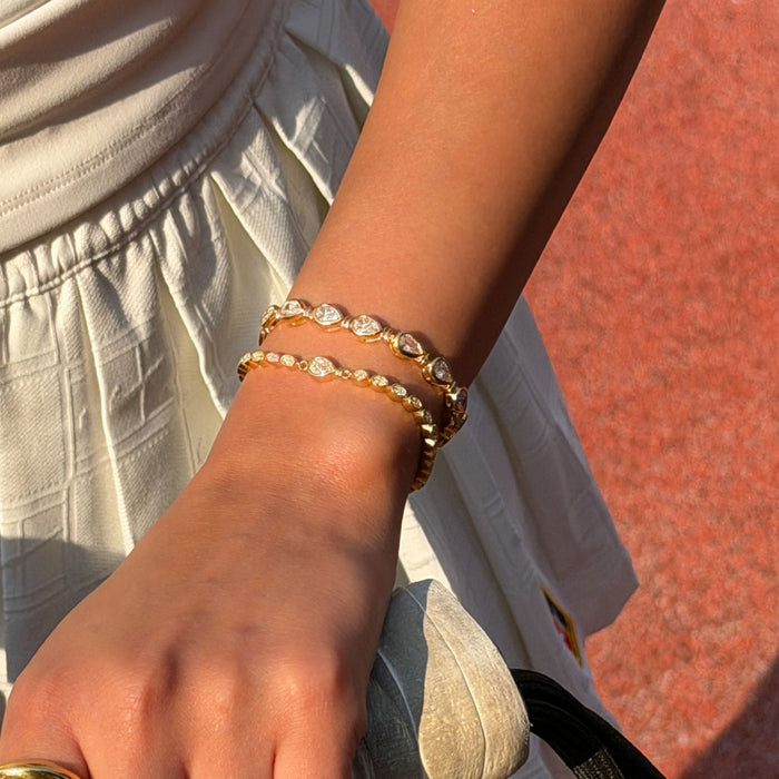model wearing padel bracelet in 18k gold vermeil with Oval stones and pavé padel racket charm.