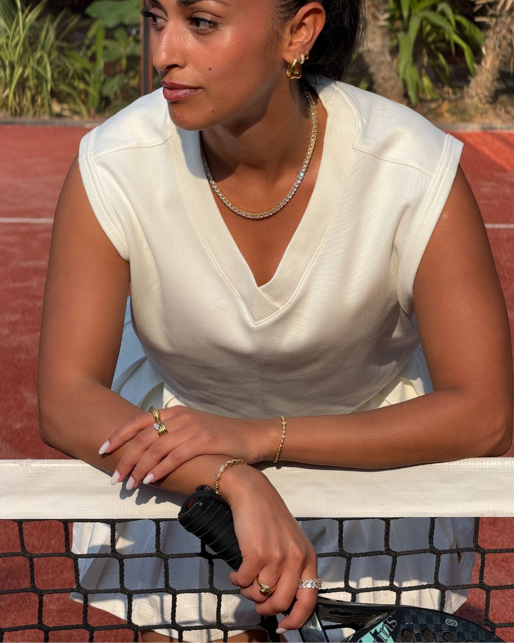 model wearing padel bracelet in 18k gold vermeil with Oval stones and pavé padel racket charm.