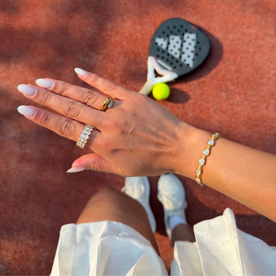 model wearing padel bracelet in 18k gold vermeil with Oval stones and pavé padel racket charm.