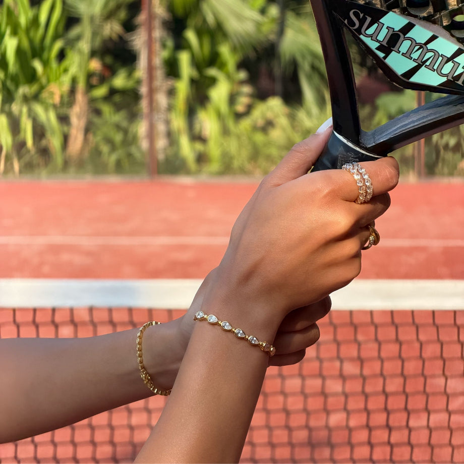 model wearing padel bracelet in 18k gold vermeil with Oval stones and pavé padel racket charm.
