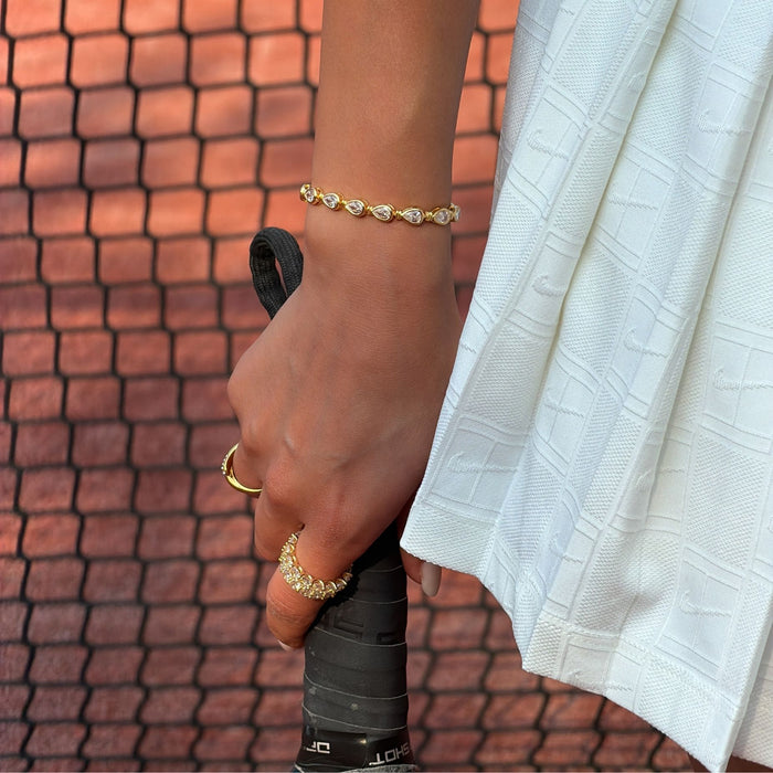 model wearing padel bracelet in 18k gold vermeil with Oval stones and pavé padel racket charm.