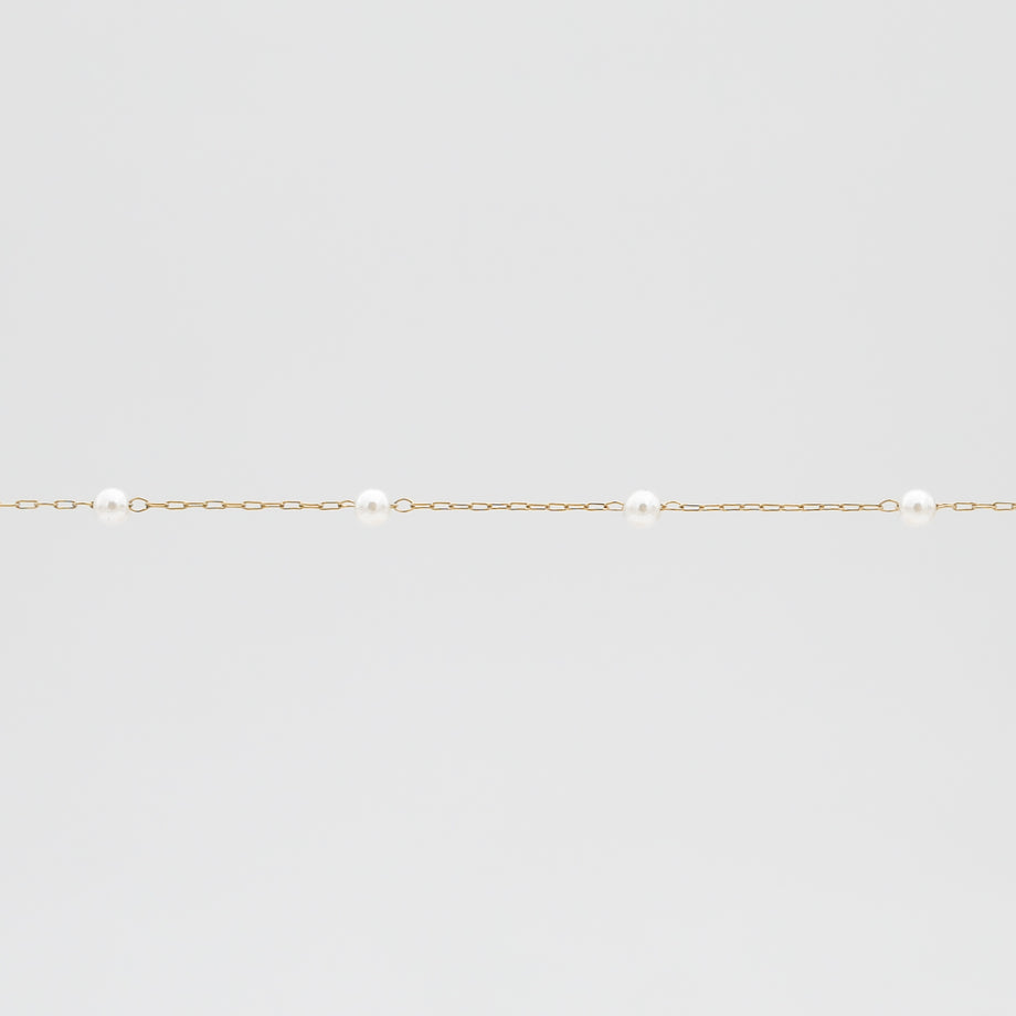 Gold chain with evenly spaced pearls.