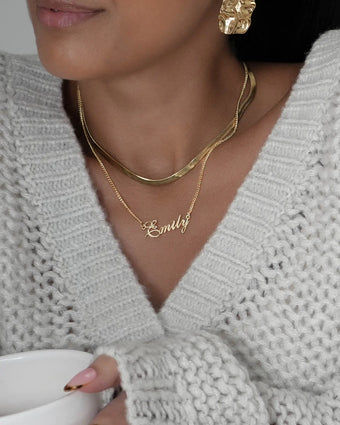 Model wearing 18k gold plated jewellery from prya, personalised name necklace, herringbone necklace, and chunky earrings