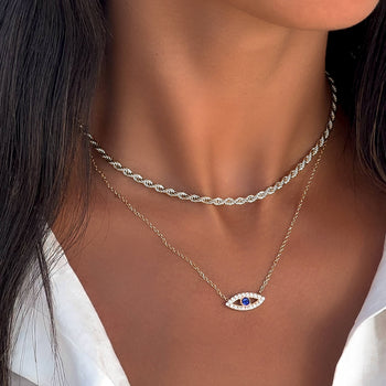 model wearing silver evil eye necklace with  paved cz stones and blue stone centre