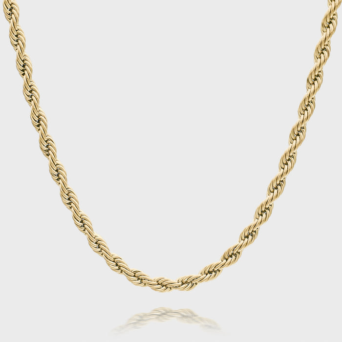 Gold rope chain necklace on white background.