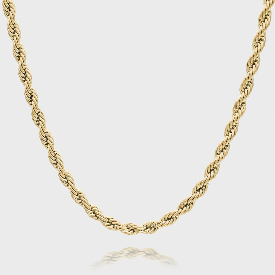 Gold rope chain necklace on white background.