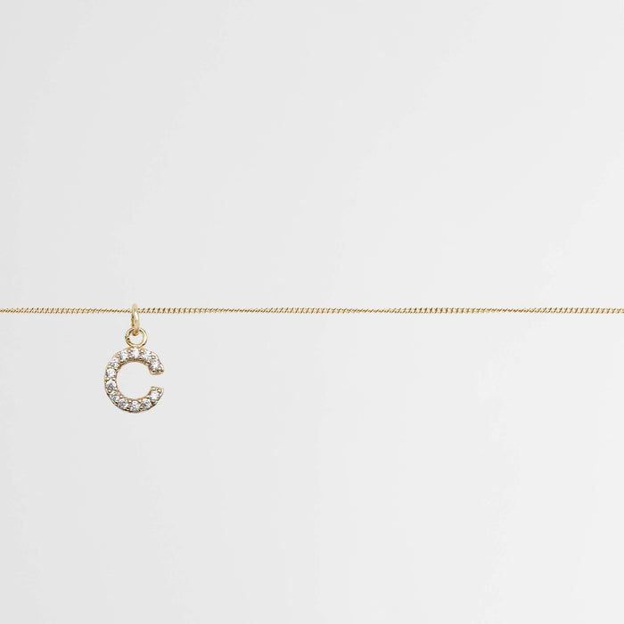 Samara ICY Initial Belly Chain with sparkling 'C' pendant on a gold mini curb chain.