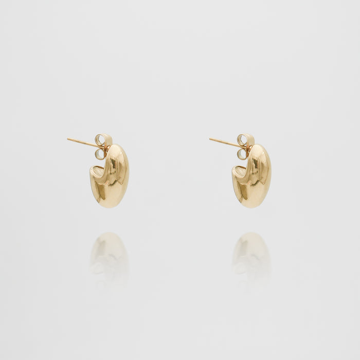 Two gold hoop earrings on white background.