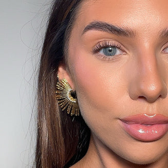 model wearing Solana fan earrings in 18k gold plated from prya