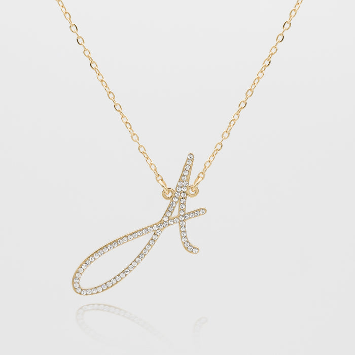 Gold necklace with a crystal letter 'A'.