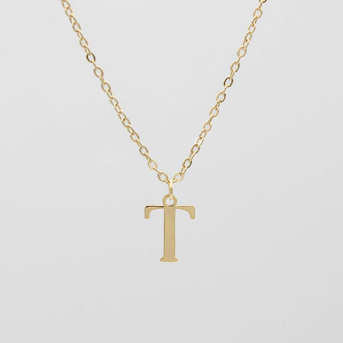 Gold plated initial necklace featuring the letter "T" on a delicate chain, perfect for personalization.