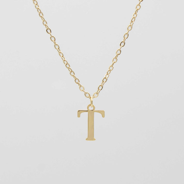 Gold plated initial necklace featuring the letter "T" on a delicate chain, perfect for personalization.