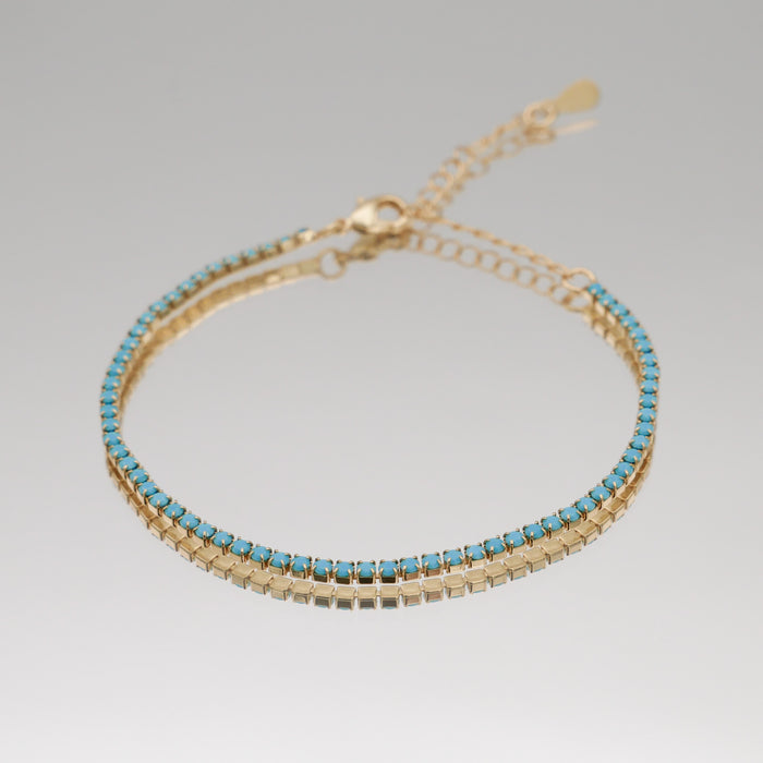 Icy tennnis cz bracelet in gold and blue gemstones