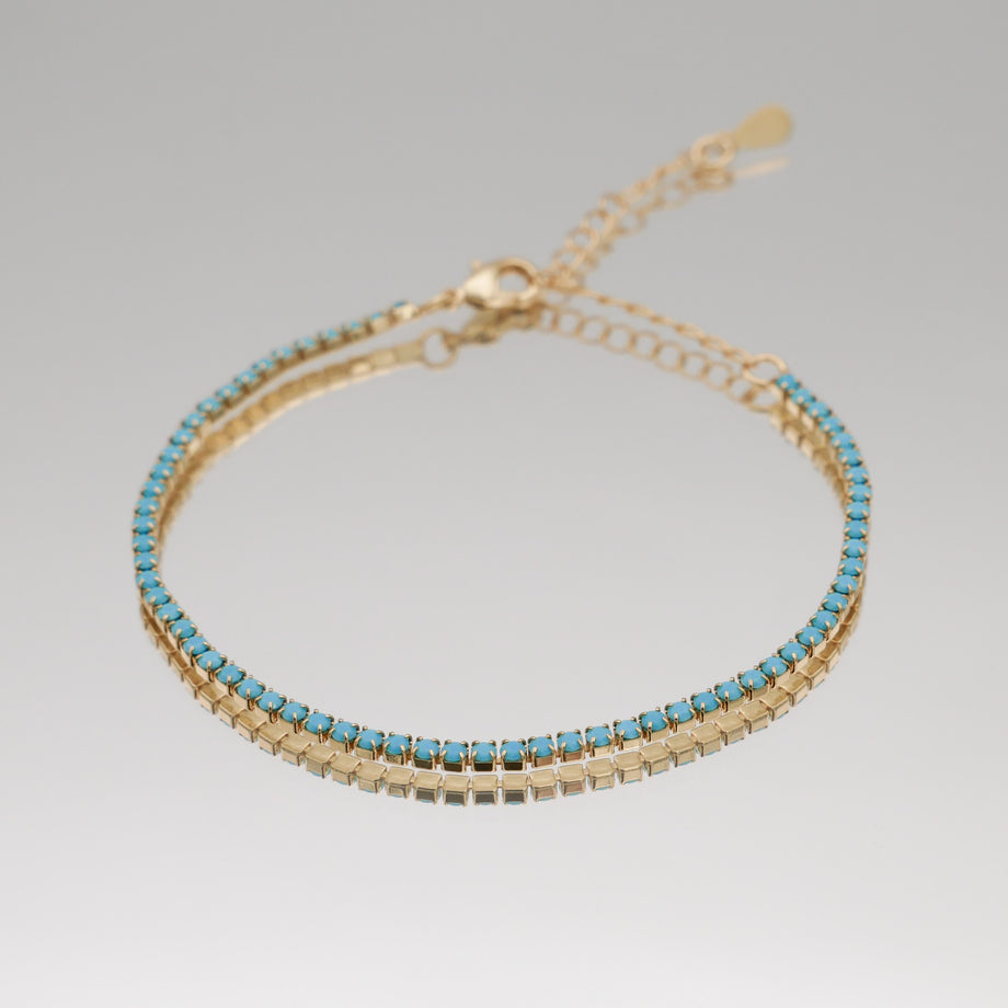 Icy tennnis cz bracelet in gold and blue gemstones