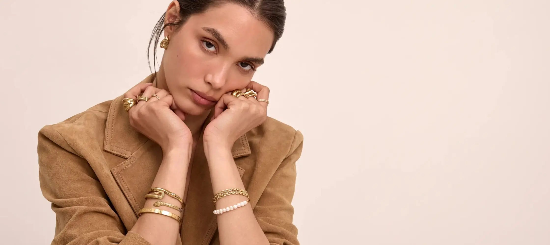 model wearing old bangles and bracelet, stacked rings and earrings from prya