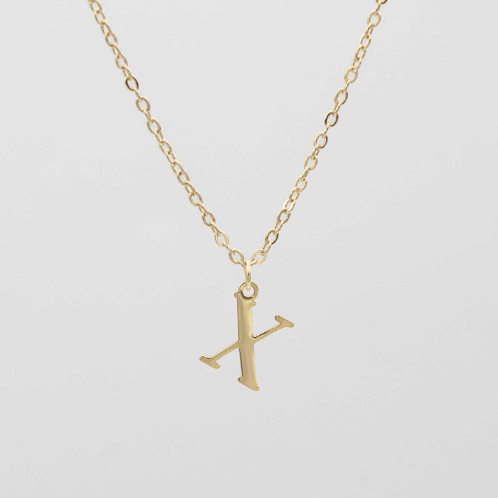 Gold plated initial necklace featuring the letter "X" on a delicate chain, perfect for personalization.