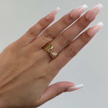 model wearing Zuri Cut-Out asymmetrical Band Ring, enhanced with shimmering CZ, crafted from 18k gold plated stainless steel from prya