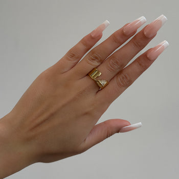 model wearing Zuri Cut-Out asymmetrical Band Ring, enhanced with shimmering CZ, crafted from 18k gold plated stainless steel from prya