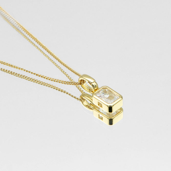 close up of emerald cut april birthstone necklace in gold from prya