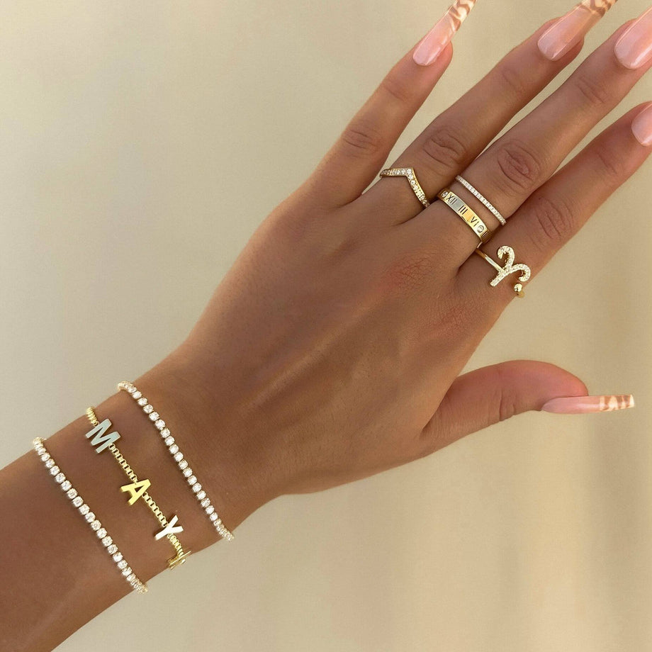 model wearing classic custom name bracelet, teamed up with rings and other bracelets from prya
