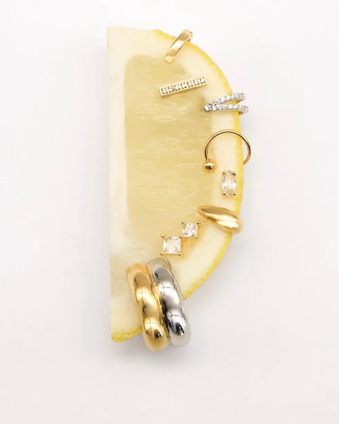 image of lemon with a range of studs, huggies, and ear cuff earrings from prya