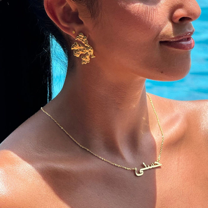 model wearing coral pearl  gold earring from prya