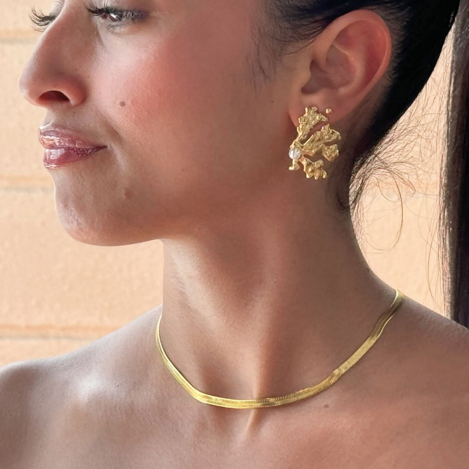 model wearing coral pearl  gold earring from prya