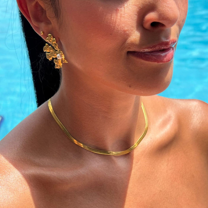 model wearing coral pearl  gold earring from prya