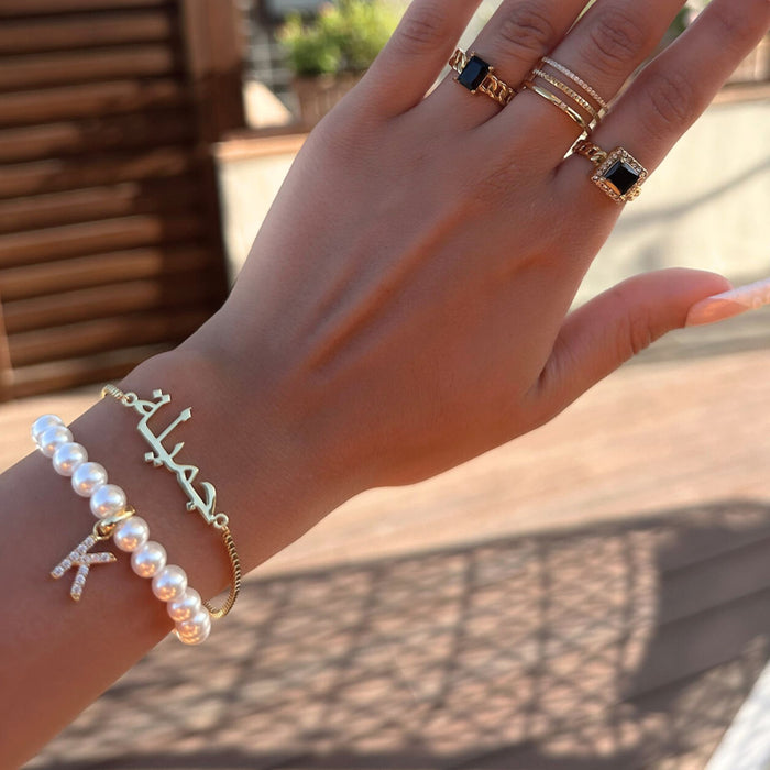 model wearing icy classic pearl initial bracelet with arabic name bracelet from prya