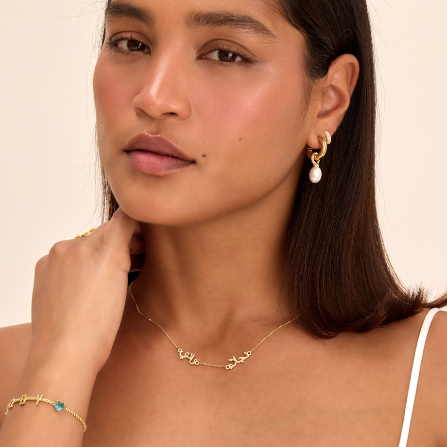 model wearing the multiple arabic name necklace in gold from prya