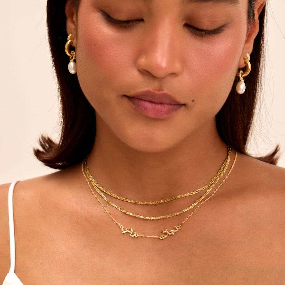 model wearing the multiple arabic name necklace in gold from prya