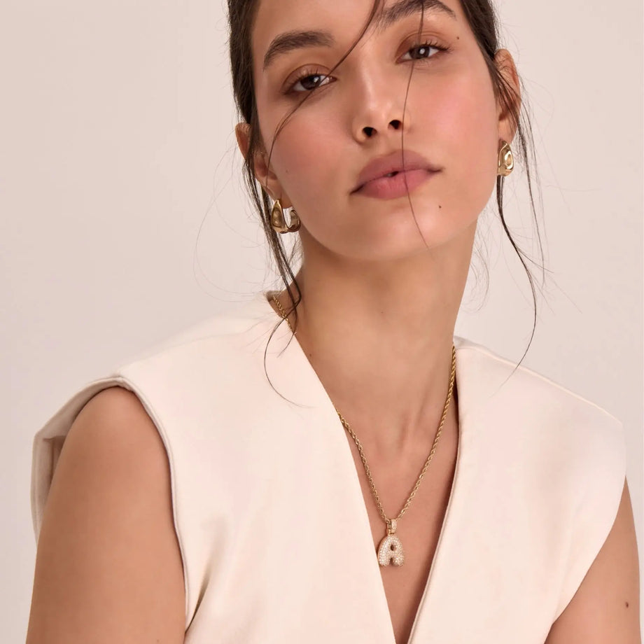 model wearing gold pave bubble initial necklace with the rope chain from prya