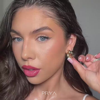 video of model wearing nadia knot knocker earring in gold from prya
