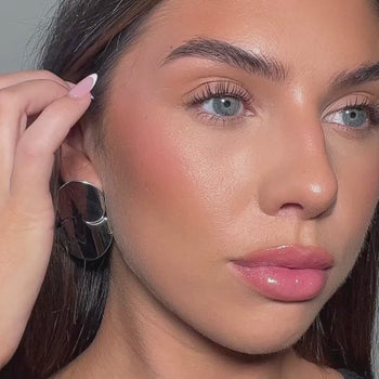 video of model wearing silver statement drop earrings from prya