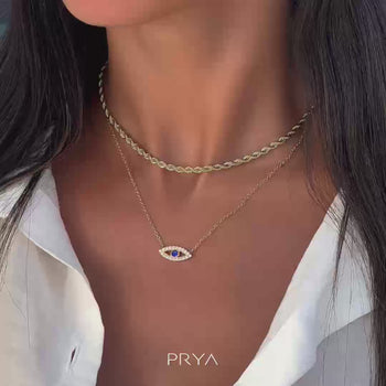 model wearing silver evil eye necklace with  paved cz stones and blue stone centre