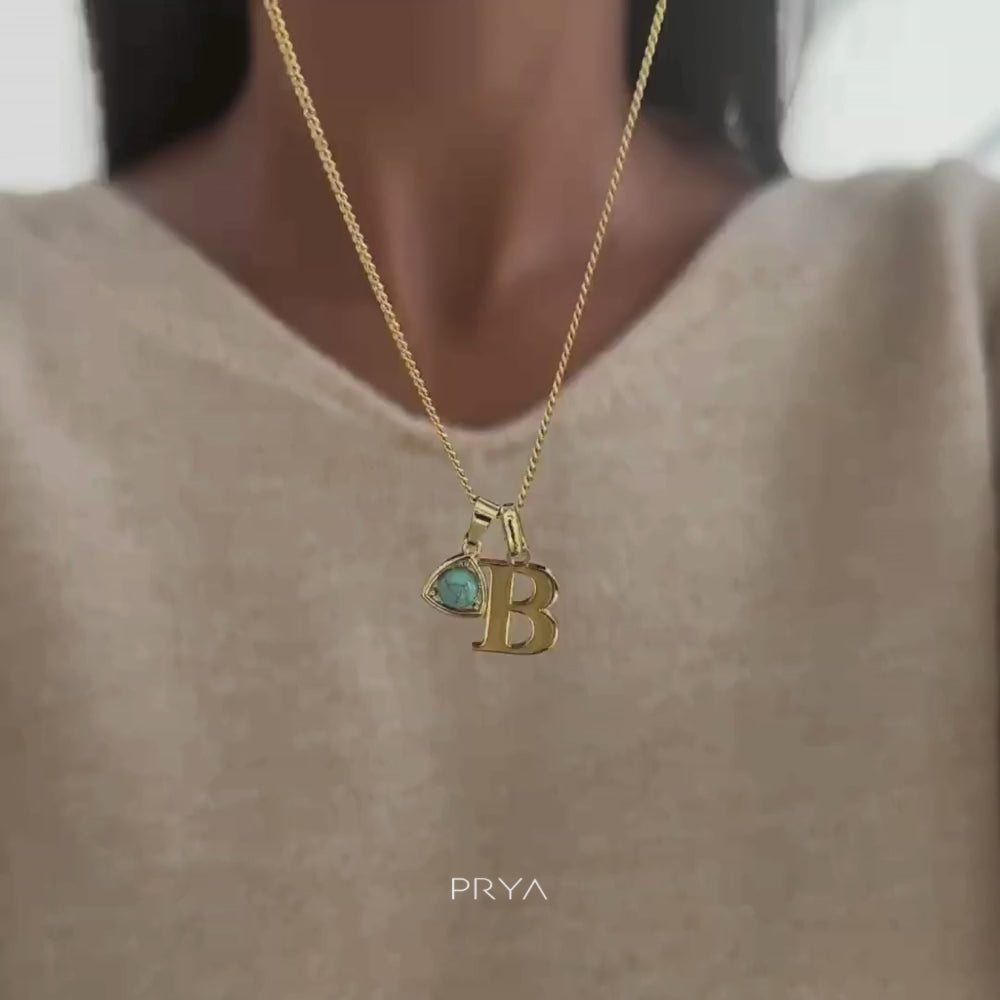 Video of Model putting on Gold initial birthstone necklace 