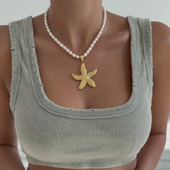 Video of Model wearing a Pearl Necklace with Gold Starfish Pendant  in different angles