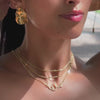 video of model wearing personalised arabic name necklace in gold layered with gold chains from prya