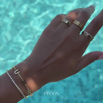 Video of Model in the swimming pool wearing Classic custom name bracelet in gold 