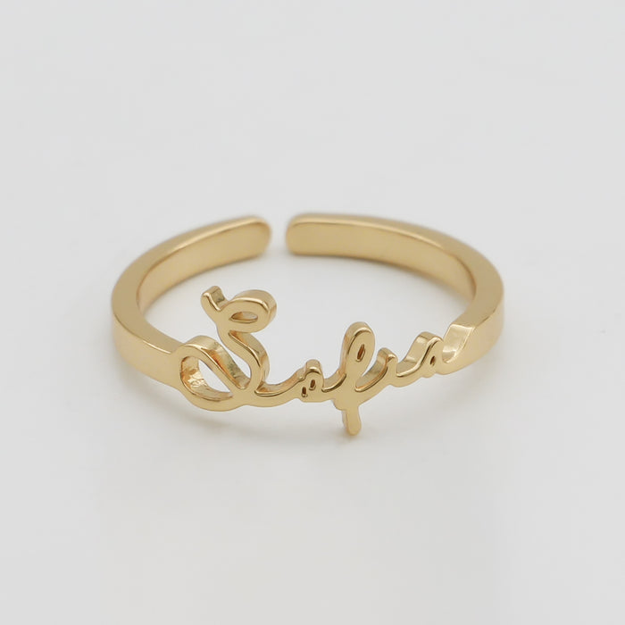 Gold ring with custom name design. 