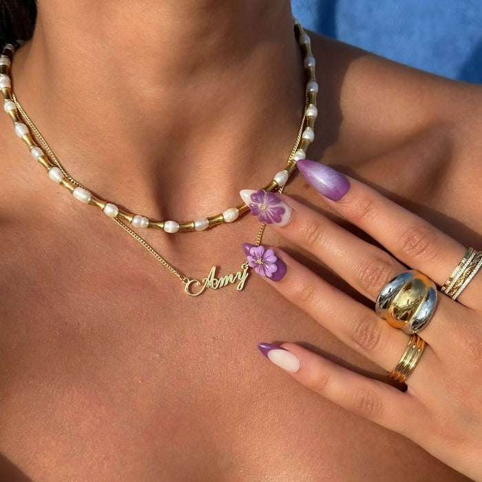 Model wearing waterproof Siena Personalised name necklace in gold by PRYA Jewellery UK