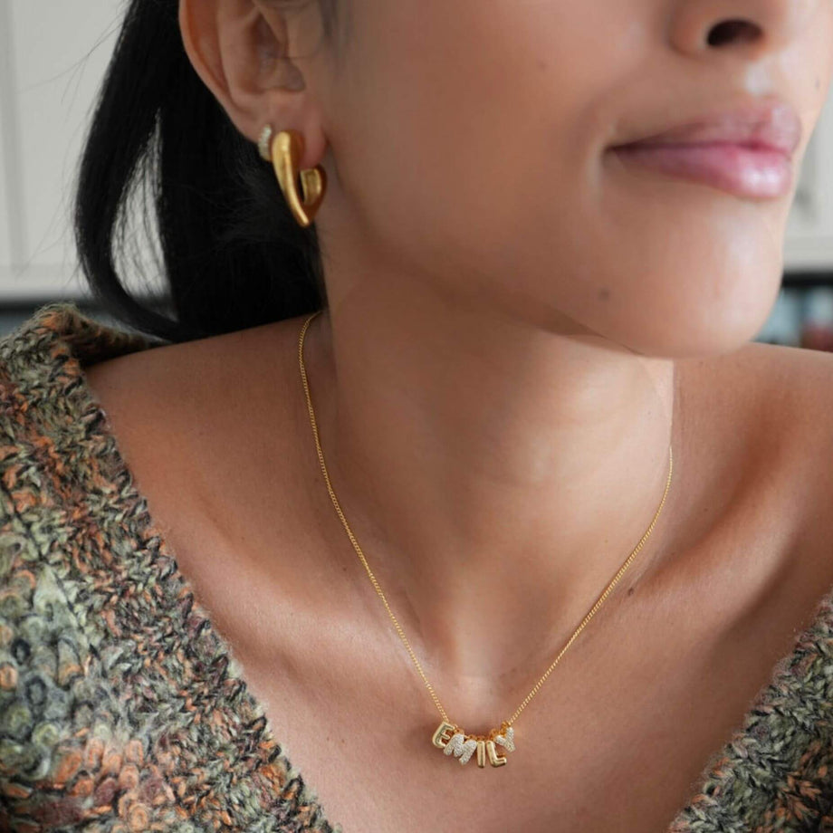 model wearing Tara half hoop earring  in gold from prya