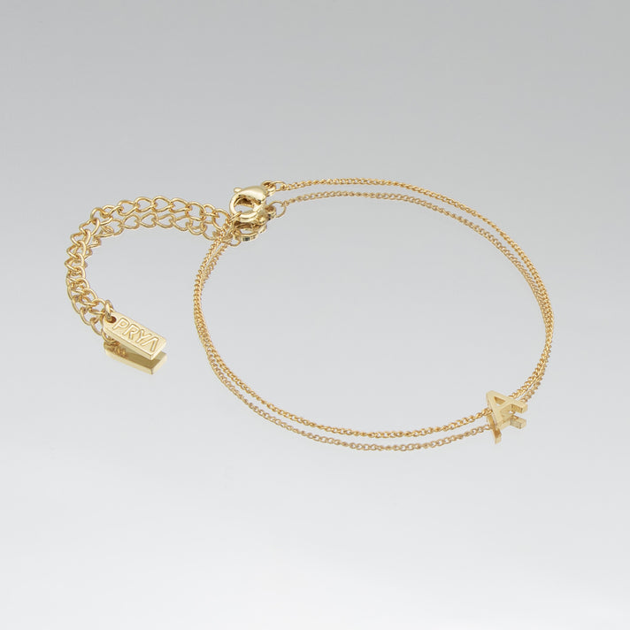 Maia Initial Bracelet in 18k gold with delicate initial pendant on a delicate chain.