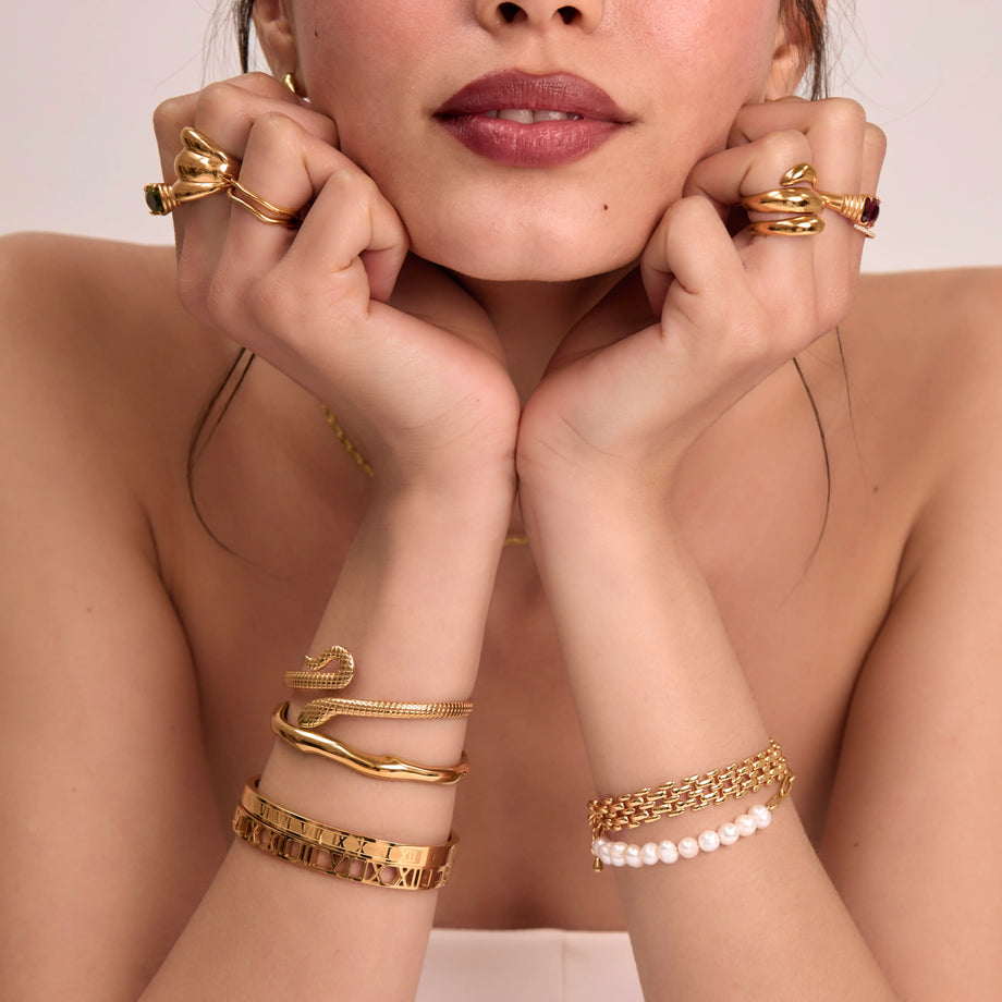 model wearing gold ring and bracelet stacks and bangles from prya