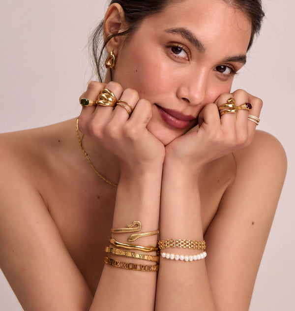 model wearing gold ring and bracelet stacks and bangles from prya