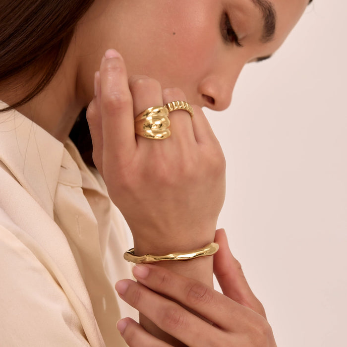 model wearing gold ring and bracelet stacks and bangles from prya