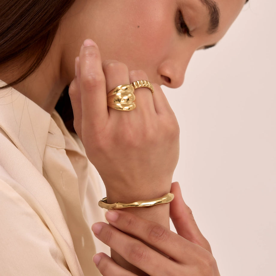 model wearing gold ring and bracelet stacks and bangles from prya