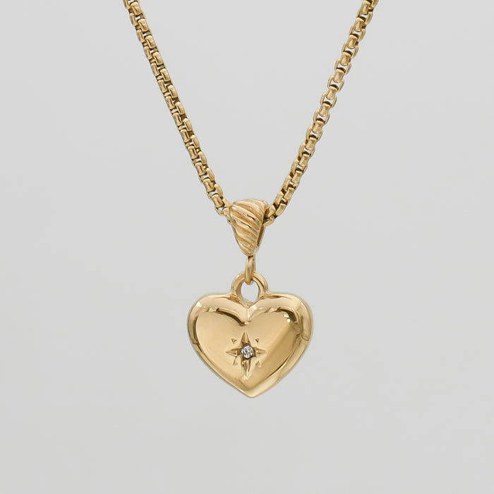 Gold heart necklace with star detail.