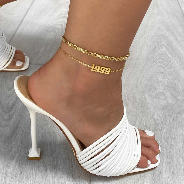 Birth Year Anklet in Gold, paired with a rope chain anklet. Both from PRYA Jewellery UK.